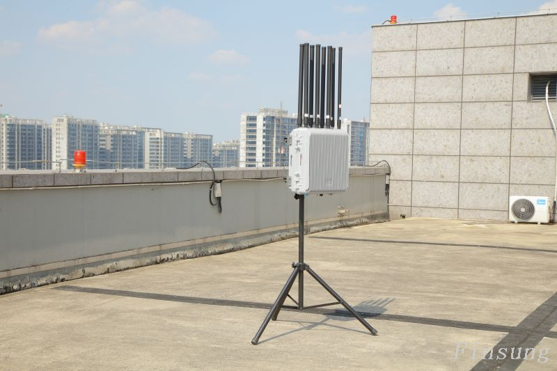Drone detection system setup with antennas, radar units, and a control screen monitoring aerial activity.